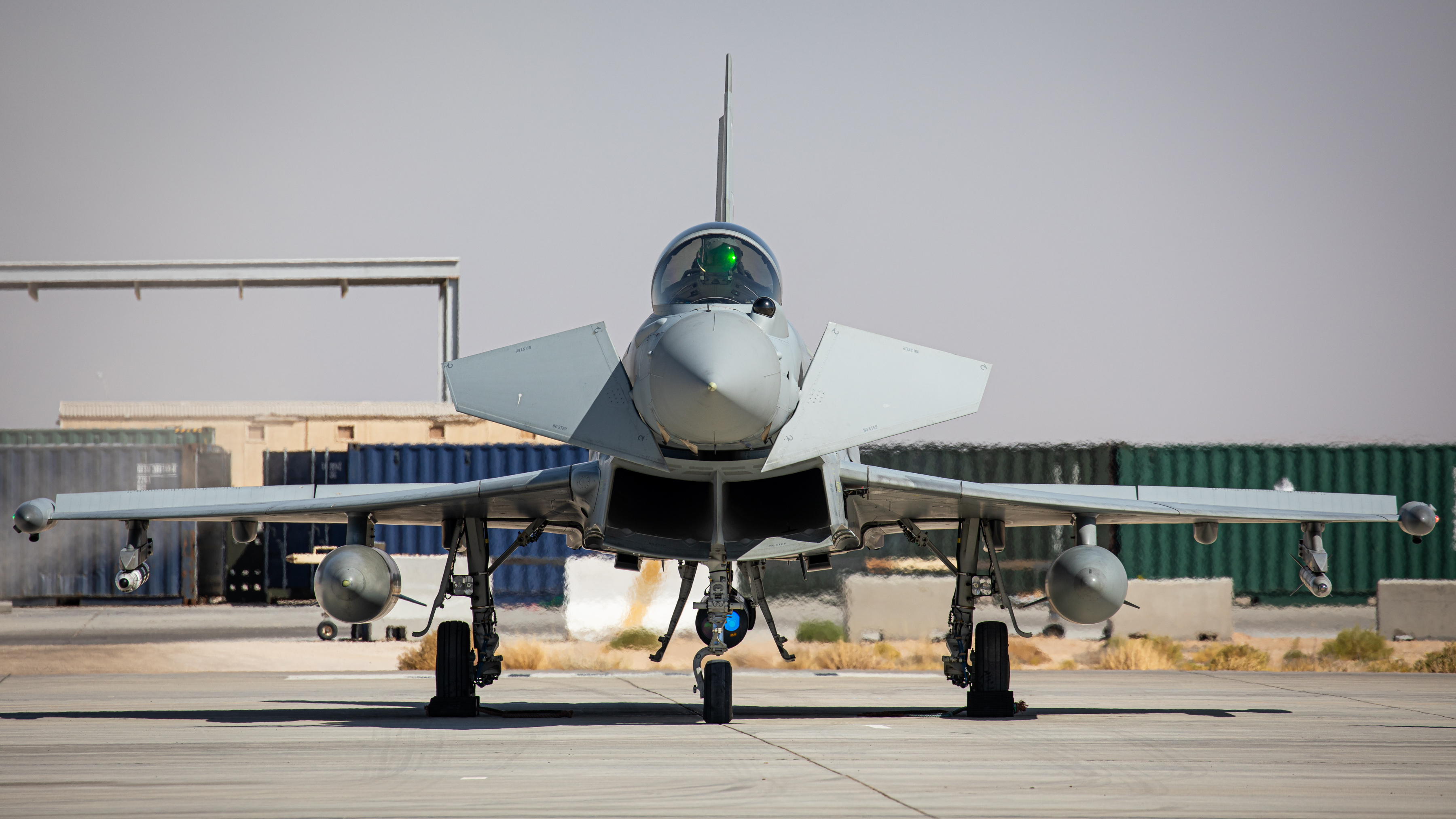 Typhoon on the airfield with crates in the background.